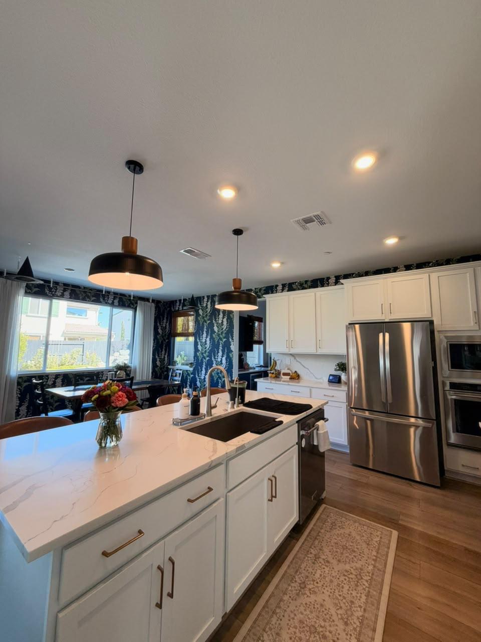 Bright kitchen with spotless island and appliances
