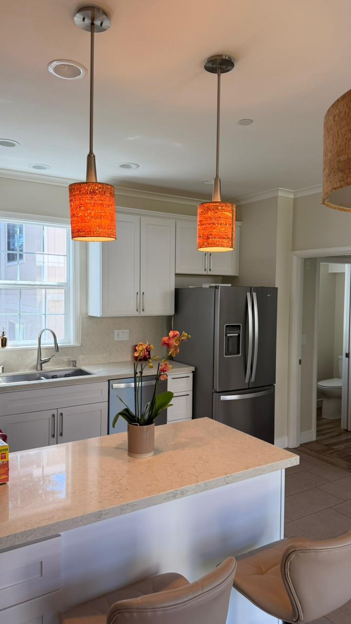 Bright kitchen with clean island and pendant lighting