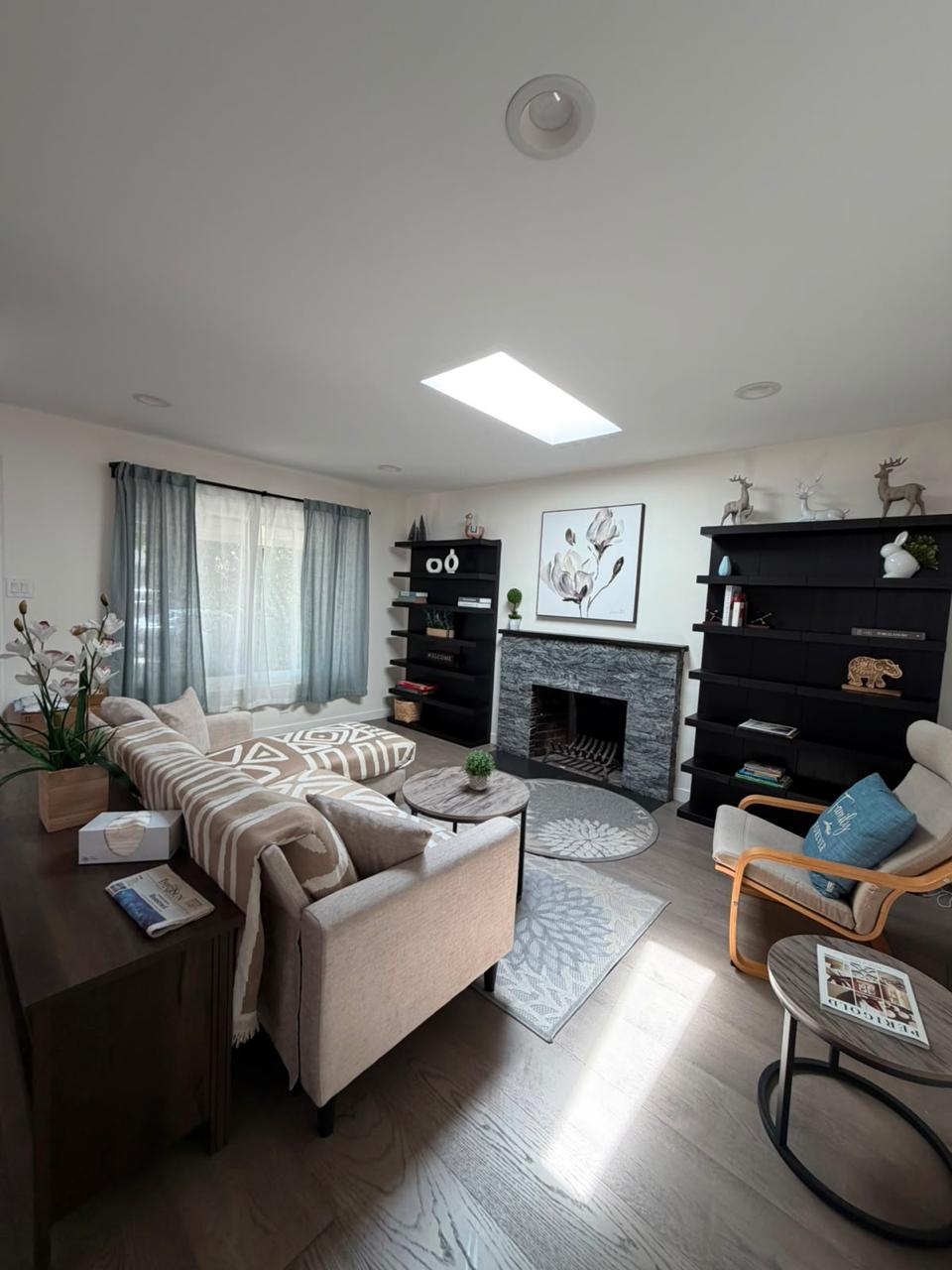 Tidy living room with seating and organized shelves